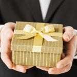 a man holding golden present box