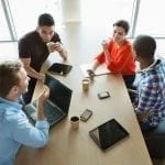 a group of people sitting around a table