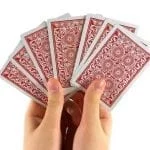 a hand holding cards in its hands