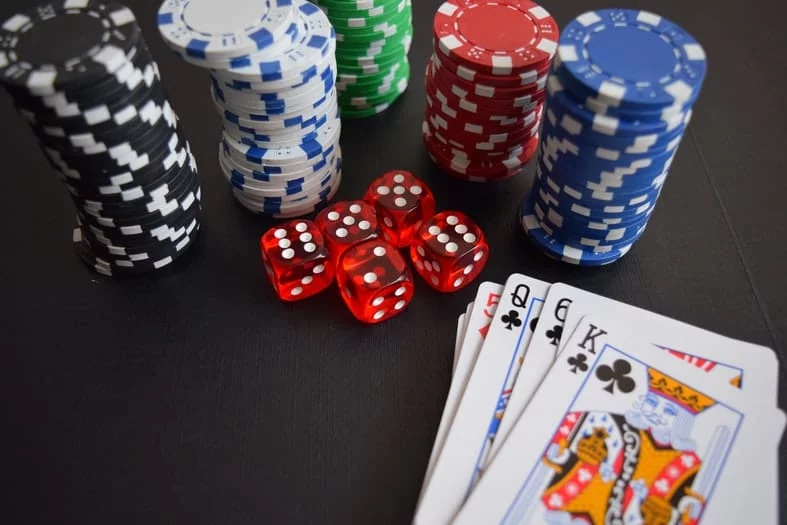 a table with cards, cubes and poker chips on it