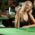 a woman holding casino cards